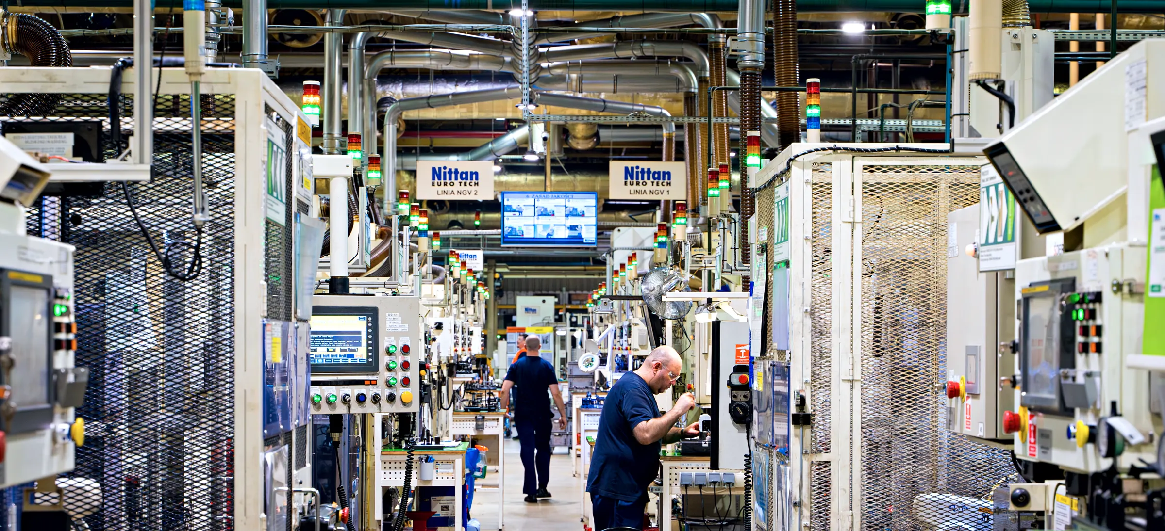 Production hall at Nittan Euro Tech in Bielsko-Biała — NGV valve lines with operators at the machines